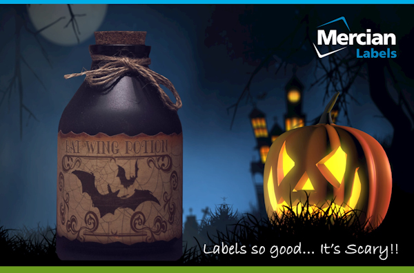 Picture of a bright Jack o Lantern / Carved Pumpkin in the foreground of a graveyard with an internally lit haunted mansion in the background on a dark night with a full, but shaded moon, with an old, short but stout glass bottle in the foreground with a label on it saying Bat Wing potion and text to the side saying ‘Labels so good… It’s scary!!’